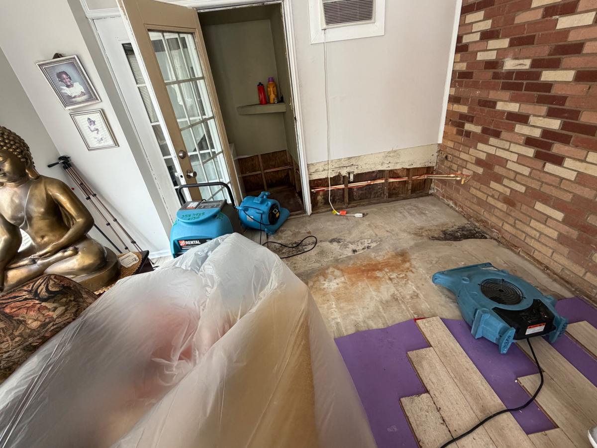 Air movers drying a flooded room